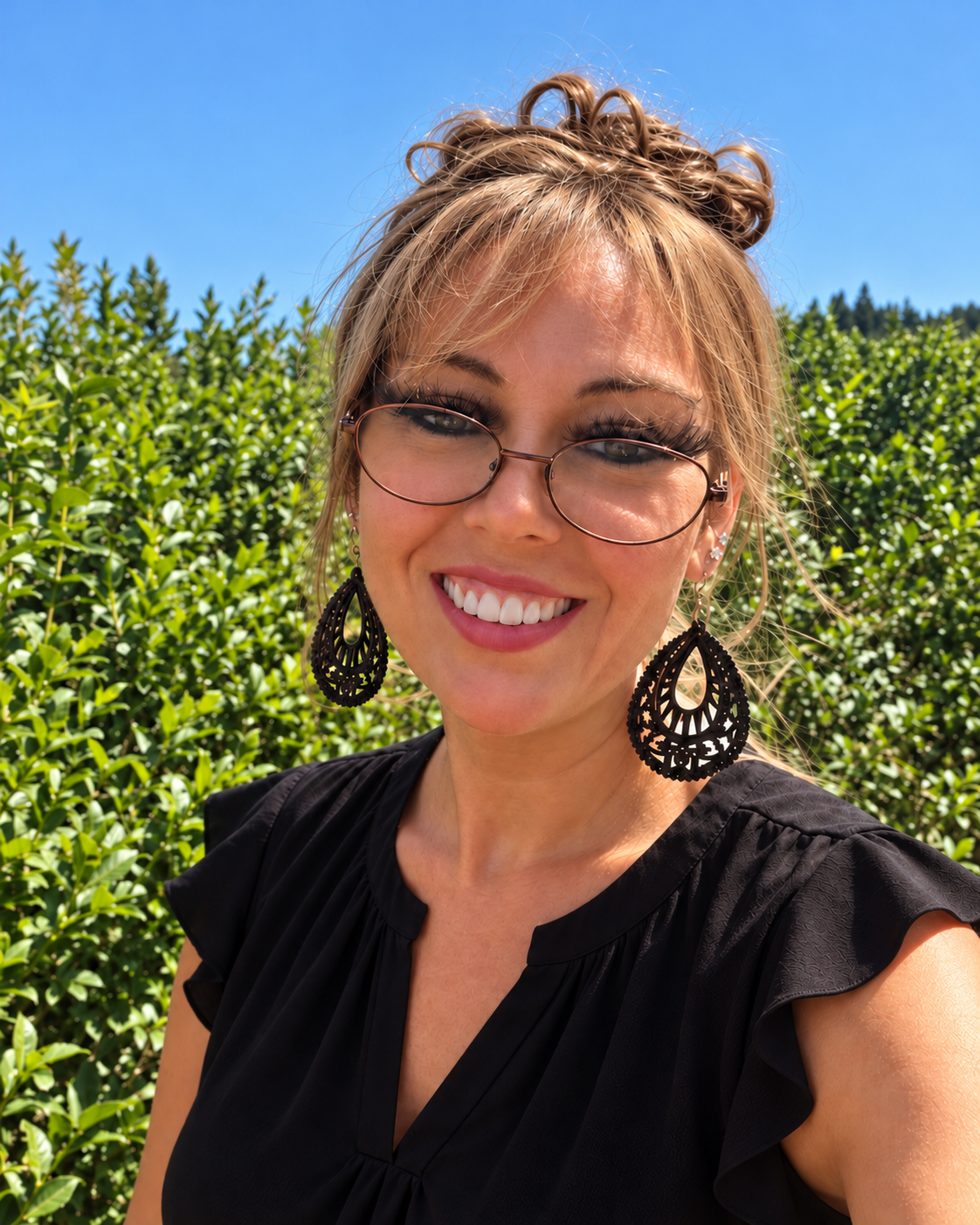 Nicole Wilkerson, LMHCA, outdoors among greenery.